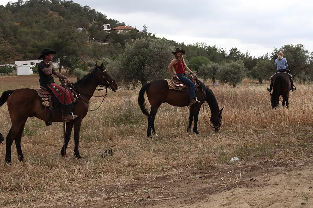 group of three riders on horses western trail riding at Rock Rose Ranch