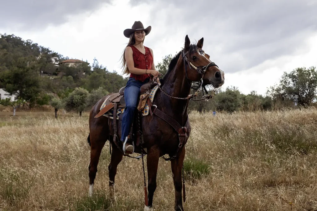 Woman seated on a horse in the Western Riding Style for Western Riding Lessons at at Rock Rose Ranch Cyprus 